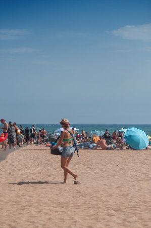 VALRAS - France - 15 August 2017 Ice cream vendor walking on the beachのeditorial素材