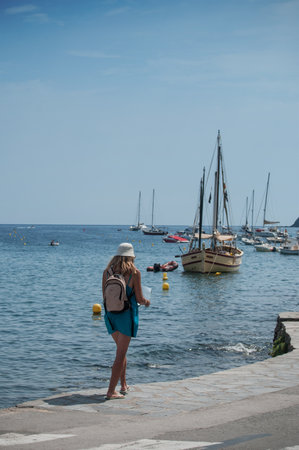 CADAQUES - Spain - 16 August 2017 - tourist walking with road mapのeditorial素材