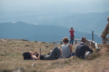 Le grand Ballon, France - 27 August 2017 - tourists sitting on the top of mountain with panorama backgroundのeditorial素材