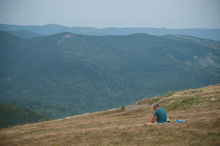 Le grand Ballon, France - 27 August 2017 - man listening music with smart phone in the top of the mountainのeditorial素材