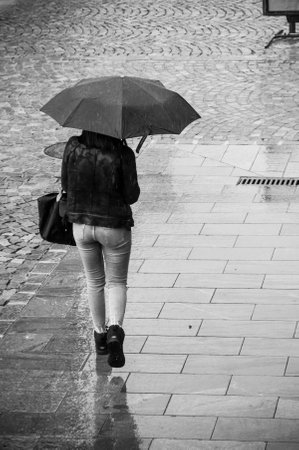 Mulhouse - France - 19 September 2017 - portrait of woman with umbrella on cobbles place in the cityのeditorial素材