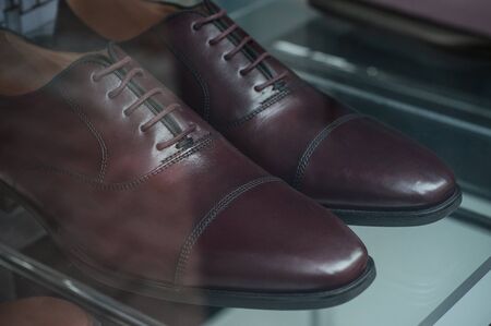 closeup of classic shoes for men in fashion store showroomの写真素材