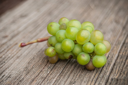 closeup of wine grape on wooden tableの写真素材
