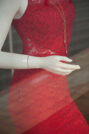 closeup of red dress on mannequin in fashion store showroom for womenの写真素材