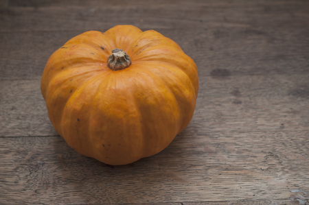 closeup of small pumpkin on wooden table backgroundの写真素材