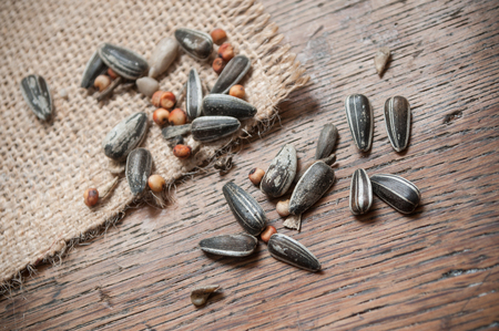 closeup of sunflower and mixed seeds on wooden backgroundの写真素材