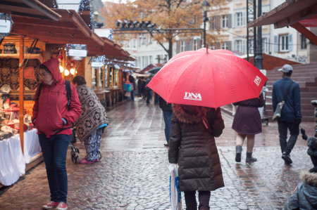 Mulhouse - France - 25 November 2017 - people with umbrella at christmas market in Mulhouseのeditorial素材
