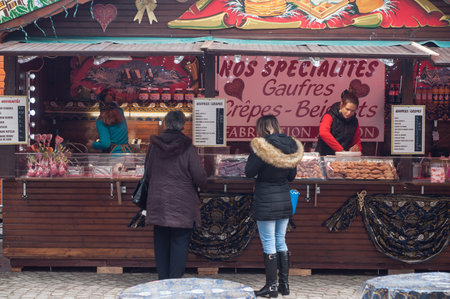 Mulhouse - France - 26 November 2017 - people standing at christmas market in front of pancakes shopのeditorial素材