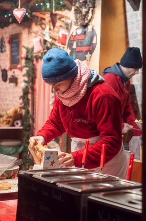 Mulhouse - France - 29 November 2017 - woman serving churros at christmas marketのeditorial素材