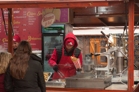 Mulhouse - France - 4 December 2017 - Woman serving churros at christmas marketのeditorial素材