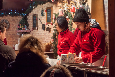 Mulhouse - France - 10 December 2017 - women serving churros at the christmas marketのeditorial素材