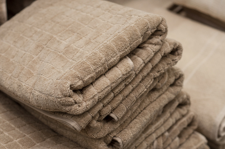 Close-up of beige bath towels pile in decoration store.の写真素材