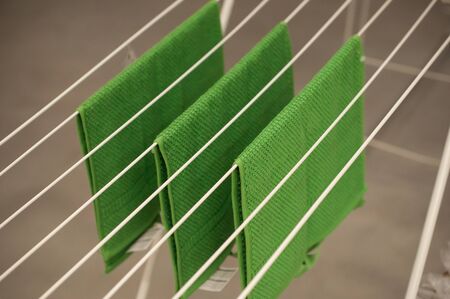 closeup of green bath towels on dryer