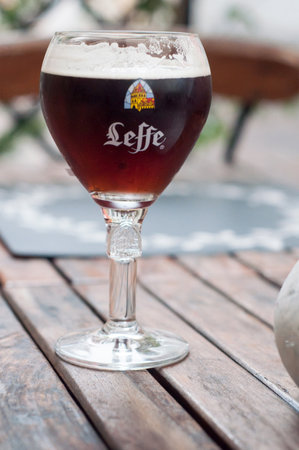 Mulhouse - France - 30 December 2017 - closeup of belgium beer Leffe in glass on table in outdoorのeditorial素材
