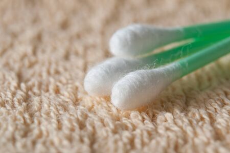 closeup of green cotton swabs on bath towel textureの写真素材