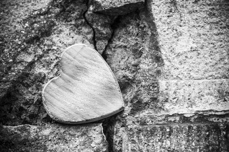 closeup of wooden heart on stoned wall in outdoor - Love conceptの写真素材