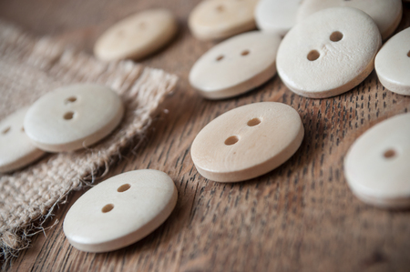 closeup of wooden sewing buttons on wooden table background の写真素材