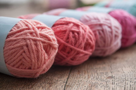 closeup of colorful wool balls on wooden table backgroundの写真素材
