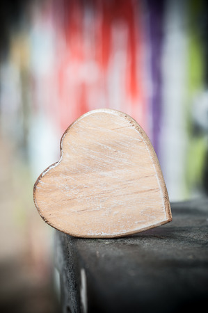 closeup of wooden heart  in outdoor on blurred graffiti wall background - Love conceptの写真素材