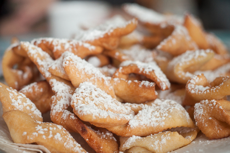 closeup of alsatian donuts with icing sugar in a plateの写真素材