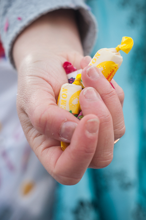 closeup of child holding candies in handの写真素材