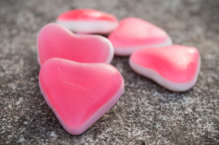 closeup of shaped heart candies on stone backgroundの写真素材