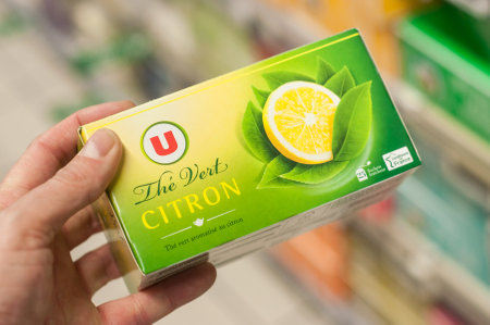 Mulhouse - France - 8 February 2018 - closeup of Lemon tea box from Super U brand in hand  at super U supermarketのeditorial素材