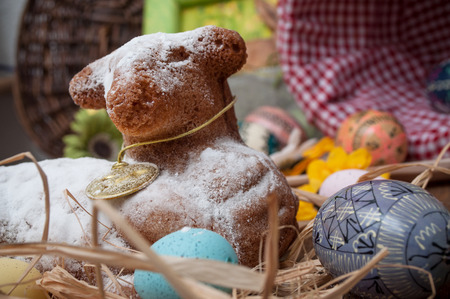 closeup of Easter lamb in cake with icing sugar with easter decorationの写真素材