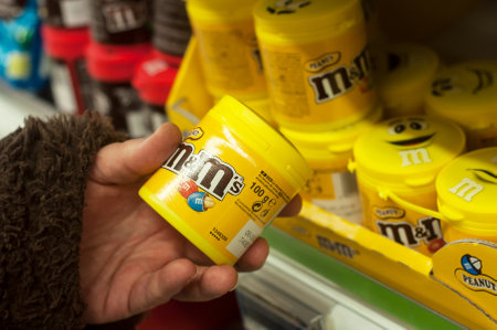 Mulhouse - France - 26 February 2018 -  closeup of chocolates from m& ms brand  in hand at Cora...