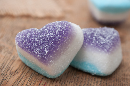 closeup of traditional candies in shaped heart on wooden background の写真素材