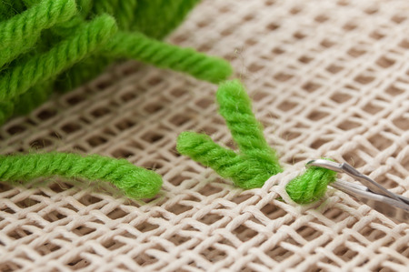 closeup of creative leisure with green wool wire on canvas 