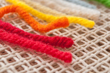 closeup of creative leisure with colorful wool wire on canvas 