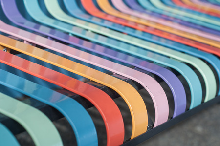 closeup of colorful metallic bench in the street の写真素材