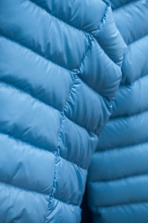 closeup of blue winter coat in fashion store showroom の写真素材