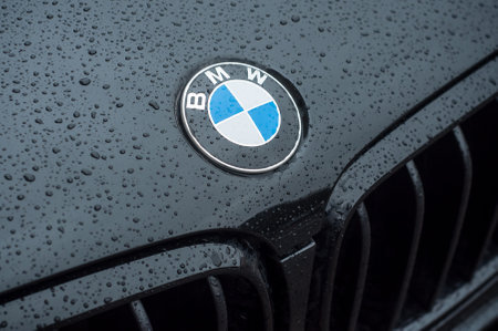 Mulhouse - France - 15 March 2018 - closeup of rain drops on black BMW car front parked in the streetのeditorial素材
