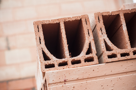 closeup of terra cotta bricks pile in construction siteの写真素材
