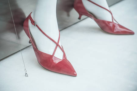 closeup of red stiletto shoes on mannequin in fashion store showroomの写真素材