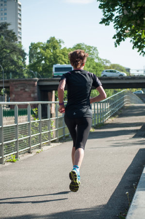 Mulhouse - France - 29 April 2018 - Woman running in border channel