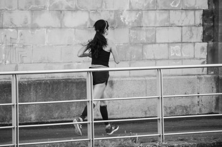 Mulhouse - France - 29 April 2018 - Woman running in border channelのeditorial素材