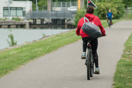 Mulhouse - France - 4 May 2018 - girl with bicycle in border channel