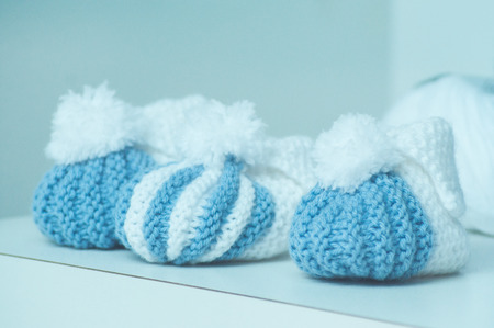 closeup of blue and white woolen baby shoes in fashion storeの写真素材