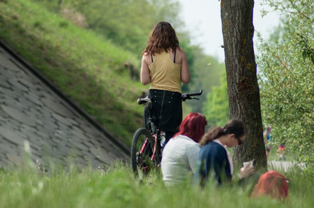 Mulhouse - France - 28 April 2018 - people sitting in park with bicycle bach vieuwのeditorial素材