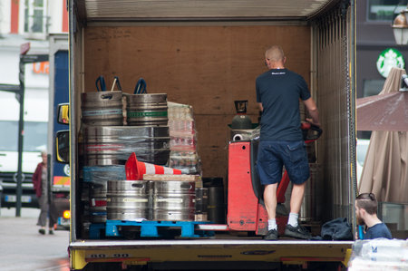 Mulhouse - France - 17 May 2018 - delivery man unloading goods from drinking delivery truck parked in the street near restaurantのeditorial素材