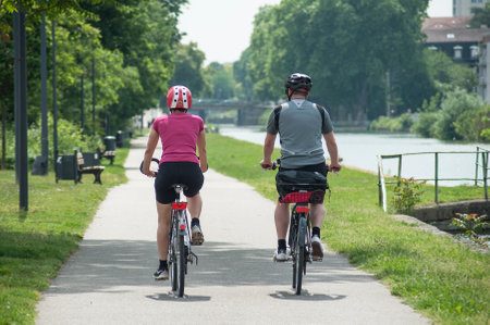 Mulhouse - France - 22 May 2018 - couple with bicycle in border riverのeditorial素材