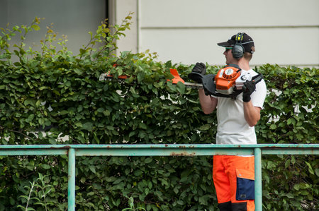 Mulhouse - France - 6 June 2018 - Professional gardener holding hedge trimmer in his hands