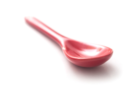 closeup of red spoon on white backgroundの写真素材