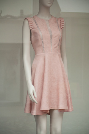 Closeup of pink summer dress on mannequin in fashion store showroomの写真素材