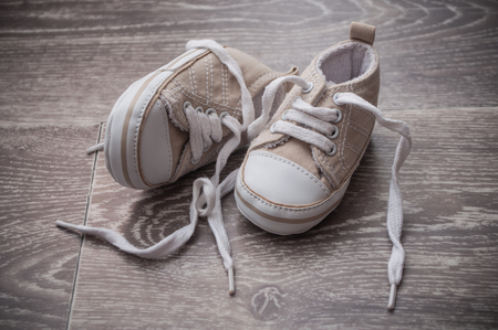 Closeup of baby sneakers on the floorの写真素材