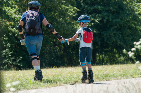 Mulhouse - France - 20 June 2018 - woman and child with helmet in roller blade in border channel