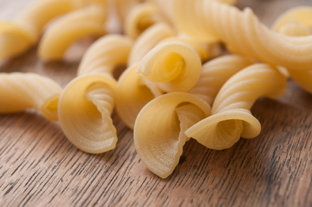Closeup of penne pasta on wooden backgroundの写真素材